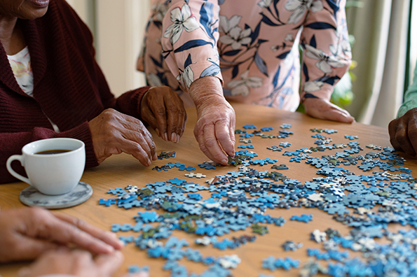 A group of seniors assembling a puzzle at a table